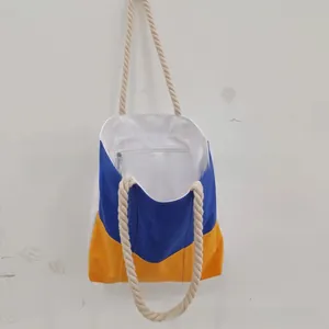 Detail view of tote bag with rope handles, patchwork design, and inner zipper pocket