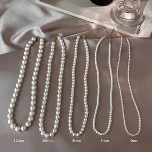Comparison of five pearl necklace sizes from 4mm to 12mm on luxury silk fabric