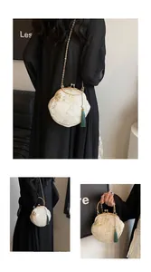 Detail of off-white Hanfu embroidery bag with gold bird motifs and green silk tassel
