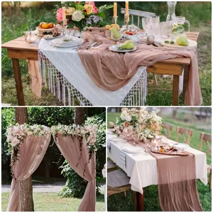 Detail of dusty rose cheesecloth table runner with natural wrinkles for wedding decor