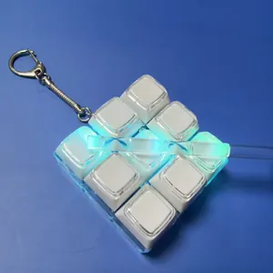 Macro view of 3x3 mechanical keyboard fidget toy with glowing LED light and keychain