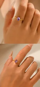 Macro detail of 18K gold plated silver ring with oval purple gemstone and chain band