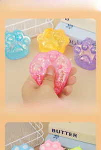 Macro detail of squishy cat paw stress relief toys with colorful glitter filling in four colors