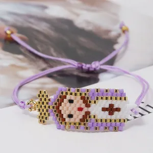 Close-up of handmade Miyuki bead bracelet with Virgin Mary pattern and adjustable purple cord