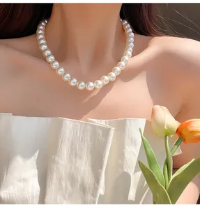 Elegant white pearl necklace worn by a model showcasing the classic clavicle chain length
