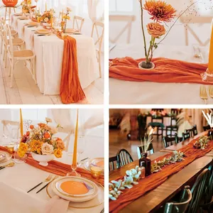 Detail view of terracota cheesecloth table runner with soft bohemian wrinkles for wedding