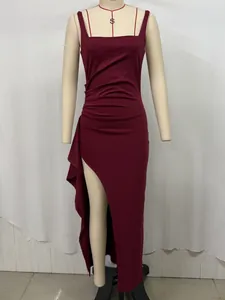 Detail of burgundy slimming maxi dress with pleated waist and side slit ruffle hem