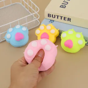 Colorful cat paw squishy stress relief toys shown being squeezed in various bright colors