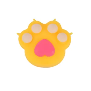 Cute yellow cat paw squishy toy with pink heart-shaped pad for stress relief