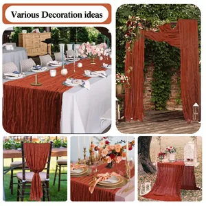Detail of terracotta cheesecloth table runner with pleated texture for wedding decor