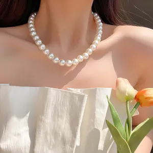 Elegant white round pearl necklace for women worn with a minimalist white dress