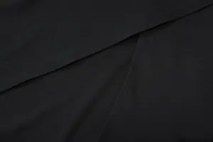 Close-up of double-stitched slit detail on a high-quality black summer dress