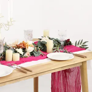 Close-up of magenta wrinkled cheesecloth table runner texture for wedding party decor