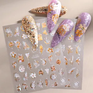 Detailed view of abstract gold nail stickers with artistic face and leaf patterns