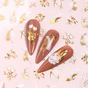 Abstract white gold nail art stickers with leaf and floral patterns on long brown nails