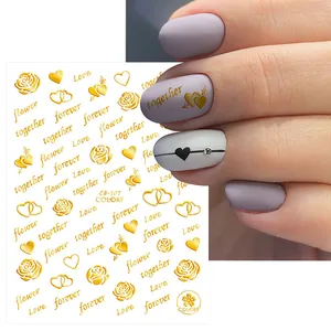 Detailed view of gold embossed nail stickers with roses and romantic love lettering
