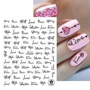 Detail of rose and heart nail art stickers featuring elegant Love and Paris typography