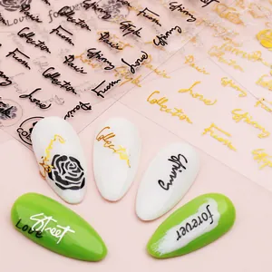 Nail art stickers with gold and black English cursive letters on white and green tips