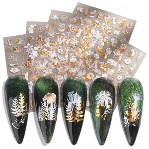 Detailed view of floral and bee gold metallic nail stickers on stiletto nails