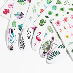 Macro detail of tropical nail stickers with palm leaves and pink flamingo patterns