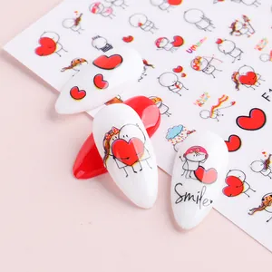 Dettaglio di adesivi 3D cartoon cuore applicati su unghie curate rosse e bianche