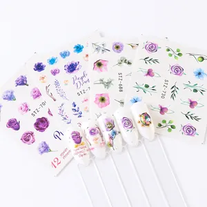 Detailed view of floral water transfer nail decals with 3D accents and stickers
