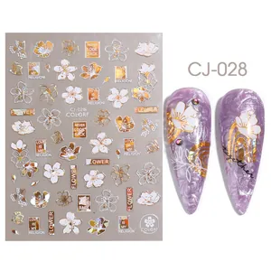 Golden floral nail stickers with elegant lettering for decorative manicure art