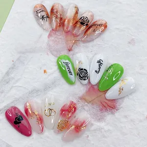 Detail of adhesive nail stickers with marble texture, rose patterns, and Love lettering