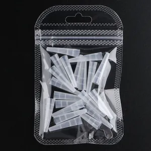 Macro shot of 25 translucent white silicone protective sleeves for eyelash tweezers tips