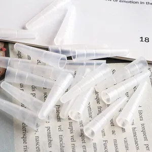 Macro detail of silicone protective caps for eyelash tweezers on a magazine page