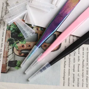 Close-up of professional tweezers with protective silicone caps in multiple colors