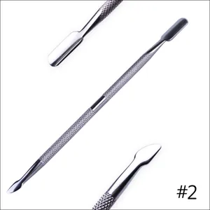 Macro detail of dual-end stainless steel nail cuticle pusher with anti-slip textured handle