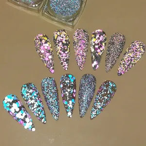 Macro shot of iridescent nail glitter and hexagonal sequins in pink, blue, and gold tones