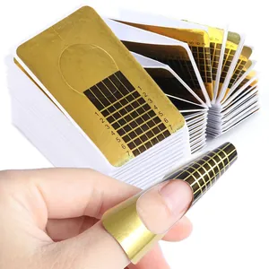 Detailed view of golden nail extension forms with 1-7 length scales for nail shaping
