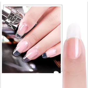 Macro shot of glossy transparent false nail extensions with a clear polished finish