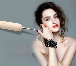 Detail of dual-ended nail dotting tool with wooden handle and metal ball tip for nail art