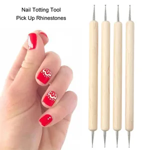 Detail of four double-ended wooden nail dotting tools with various sizes of metal ball tips