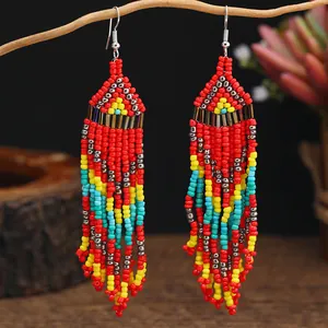 Detailed close-up of handmade beaded tassel earrings with bohemian geometric patterns