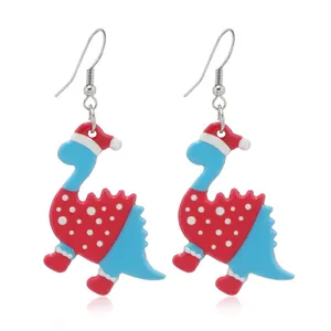 Kerst dinosaurus oorbellen met kerstmutsen in blauw en rood acryl op witte achtergrond