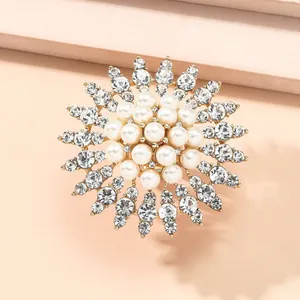 Detailed close-up of multilayer flower ring with white pearls and sparkling rhinestones