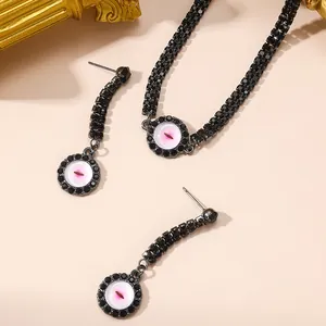 Black pavé crystal evil eye jewelry set including necklace and earrings on beige base