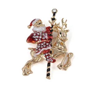 Broche Père Noël doré sur renne ornée de strass blancs brillants pour les fêtes