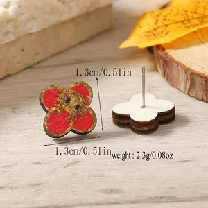 Macro shot of 1.3cm wooden floral earrings with intricate printed anime character details