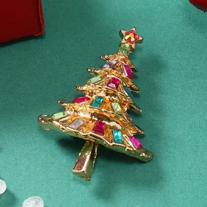 Dettaglio macro della spilla a forma di albero di Natale con strass colorati su metallo