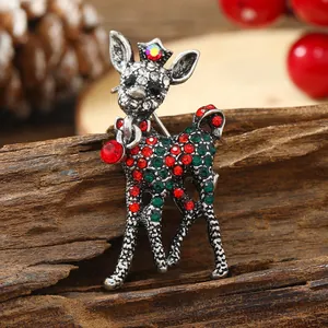 Vintage Christmas reindeer brooch with red and green rhinestones in silver finish