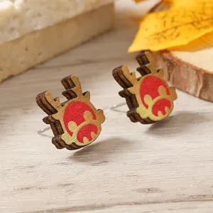 Macro view of handmade wooden reindeer earrings with laser-cut edges and natural texture