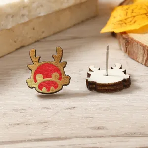 Close-up of wooden dragon earrings with red and gold patterns for Lunar New Year