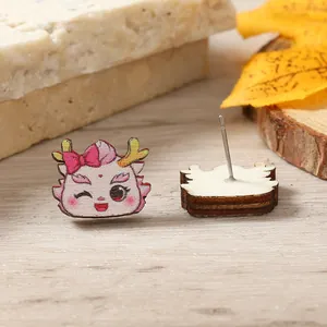 Close-up of cute cartoon wooden dragon earrings with festive Chinese zodiac patterns