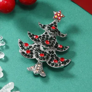Dettaglio della spilla a forma di albero di Natale con strass su sfondo festivo
