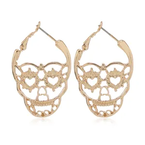Exaggerated golden skull hoop earrings with hollow heart eyes and boho floral patterns